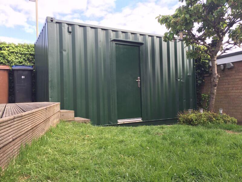 Green Shipping Container in Backyard