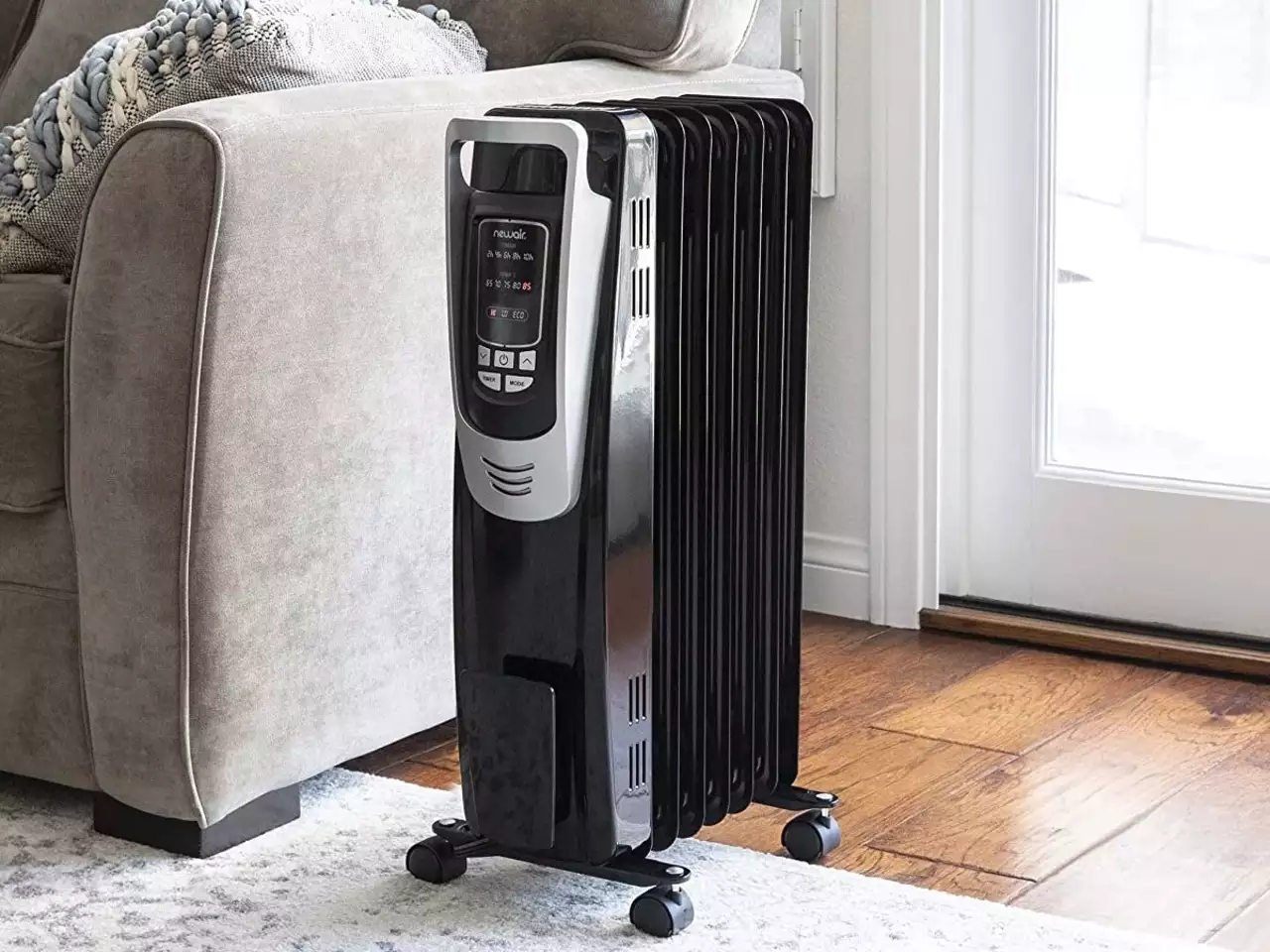Black portable heater on wooden floor - efficient heating with diathermic oil