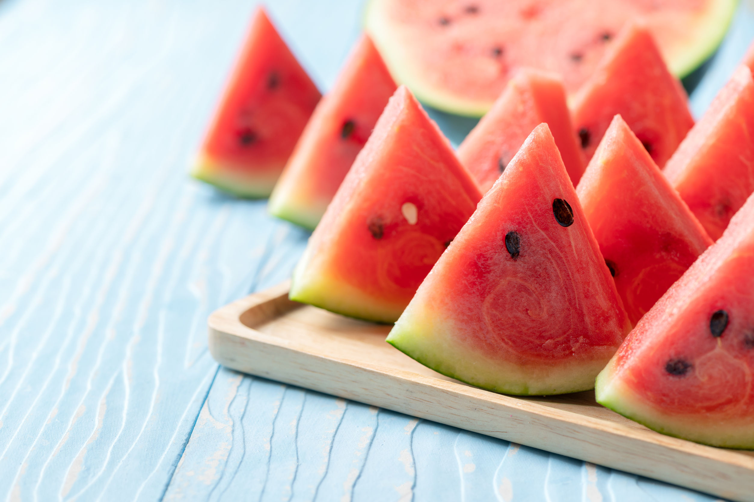Watermelon slices on a wooden tray