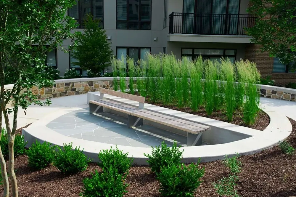 A circular garden bench amidst greenery, highlighting the harmony between nature and relaxation. Environmental Impact
