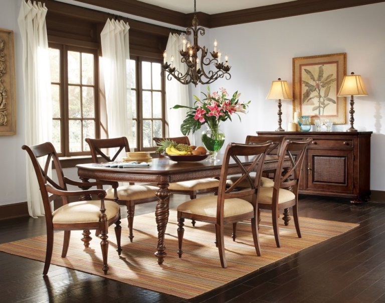 A dining room table with chairs and a chandelier