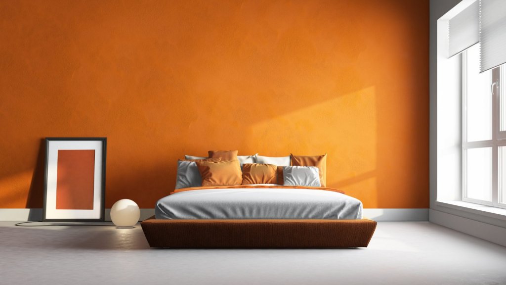 A cozy orange bedroom with a comfortable bed