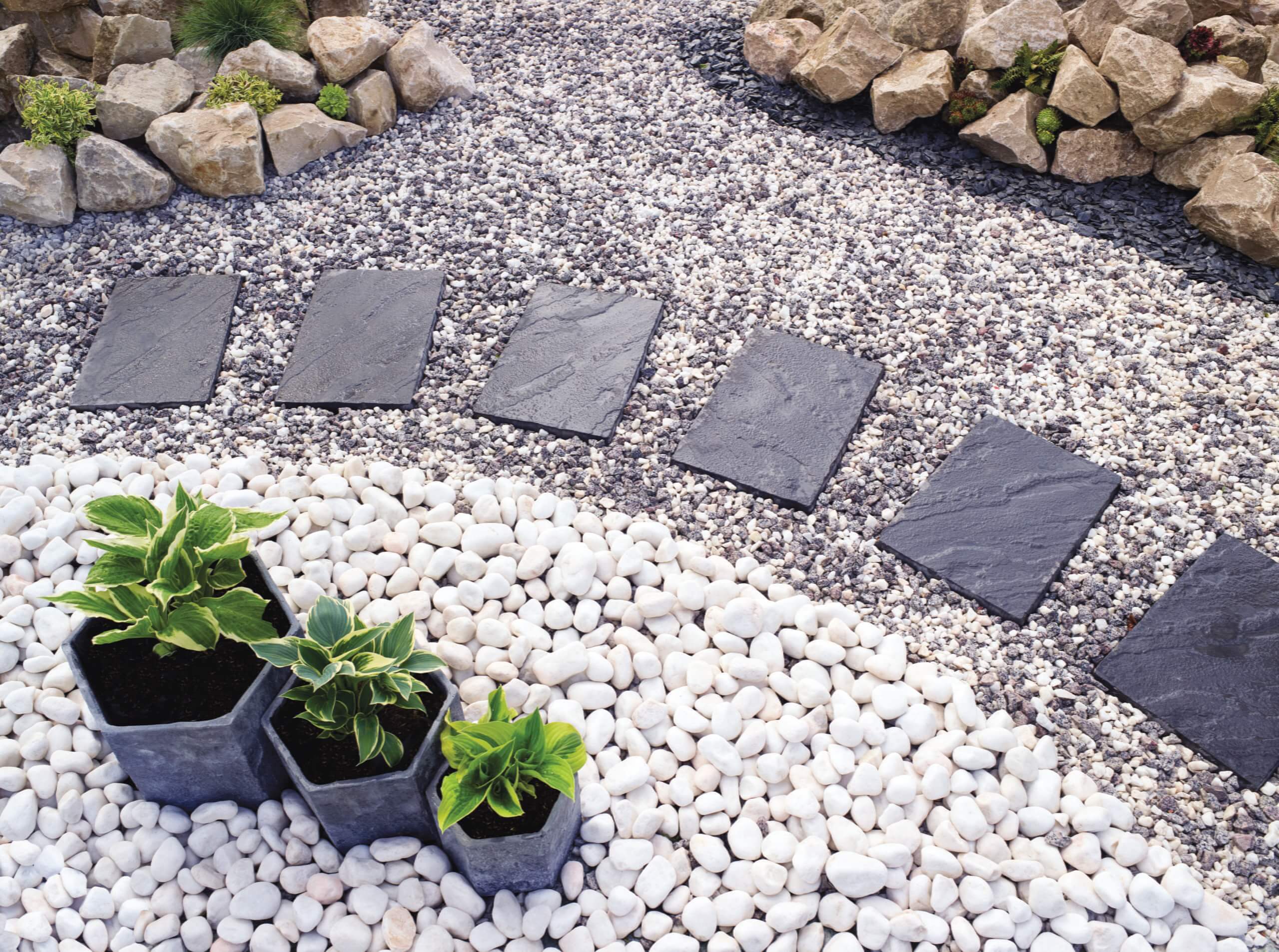 A gravel path winding through plants and stones. Plan for Delivery and Installation