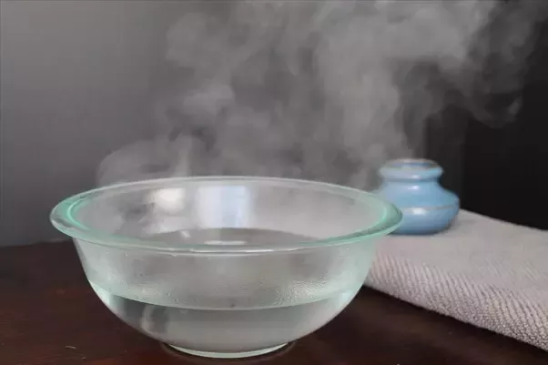 A bowl of warm water emitting steam