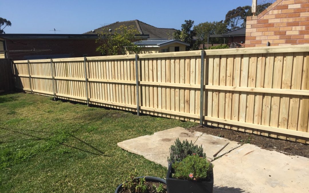 Timber fencing with wooden posts and a planter, creating a charming boundary