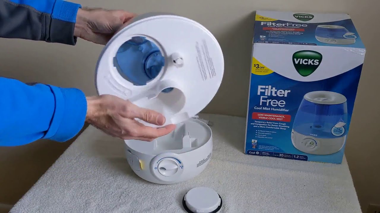 A person opening the lid of a humidifier