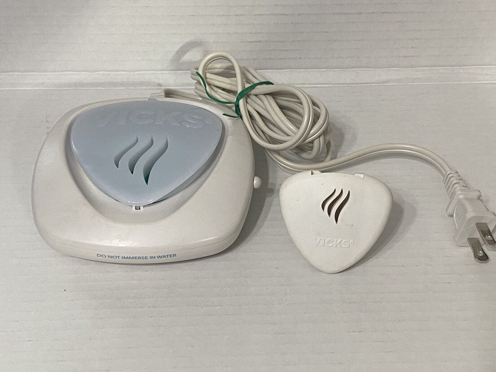 White electronic device with cord and plug - Vicks Plug-in Waterless Vaporizer
