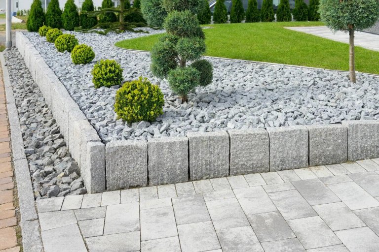 A stone retaining wall with a small tree nestled within