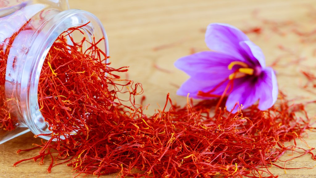 jar of saffron and a flower on a table