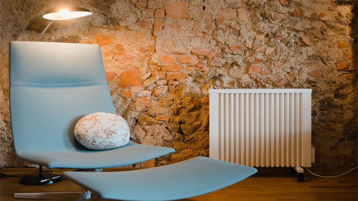 A chair and a radiator placed against a stone wall, creating a cozy and rustic ambiance