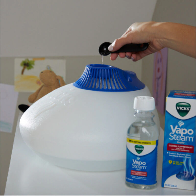 person cleaning a white container with a bottle