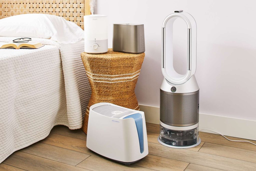 a white and gray air purifier sits on a wooden floor, purifying the air in the room