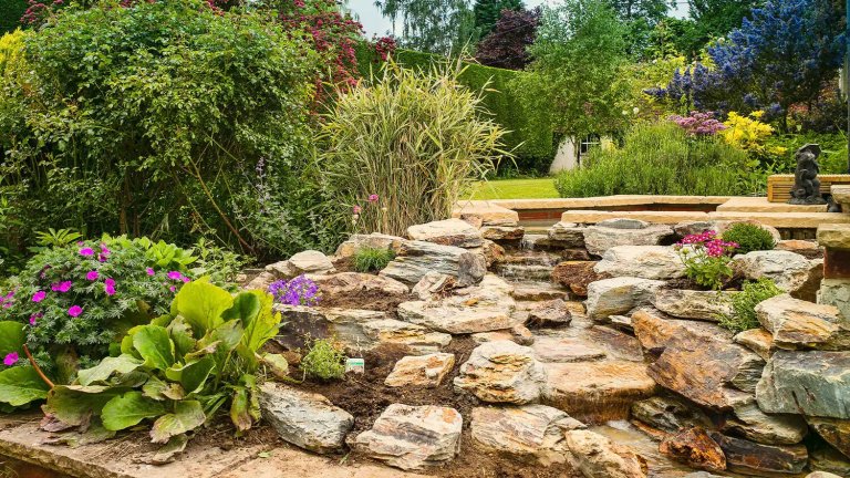 A beautiful garden with colorful flowers and rocks. Find landscaping rocks on public land.