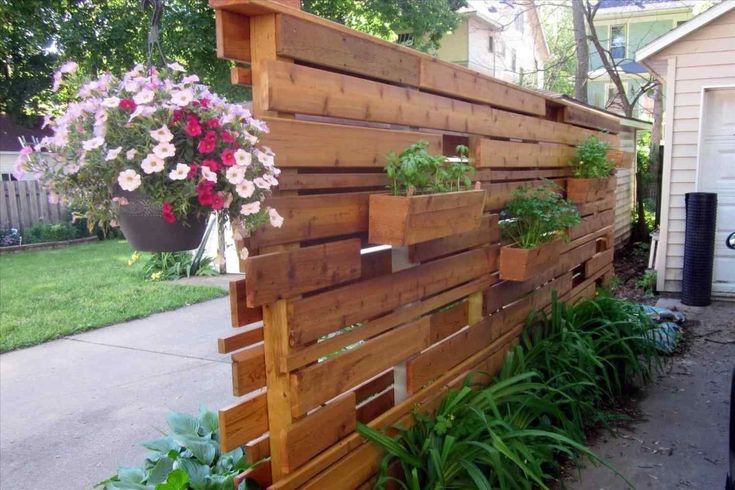 A decorative wooden wall with plant holders