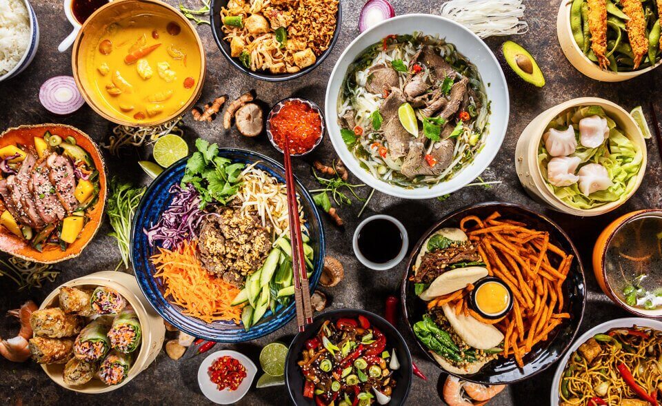 A diverse assortment of food displayed in bowls, representing various cuisines from around the world