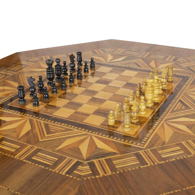 A wooden table with a chess board and two chairs, set for a game. A classic setup for strategic battles.