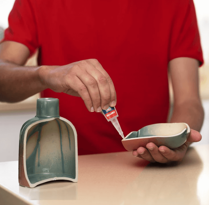 A person pouring liquid into a small bowl
